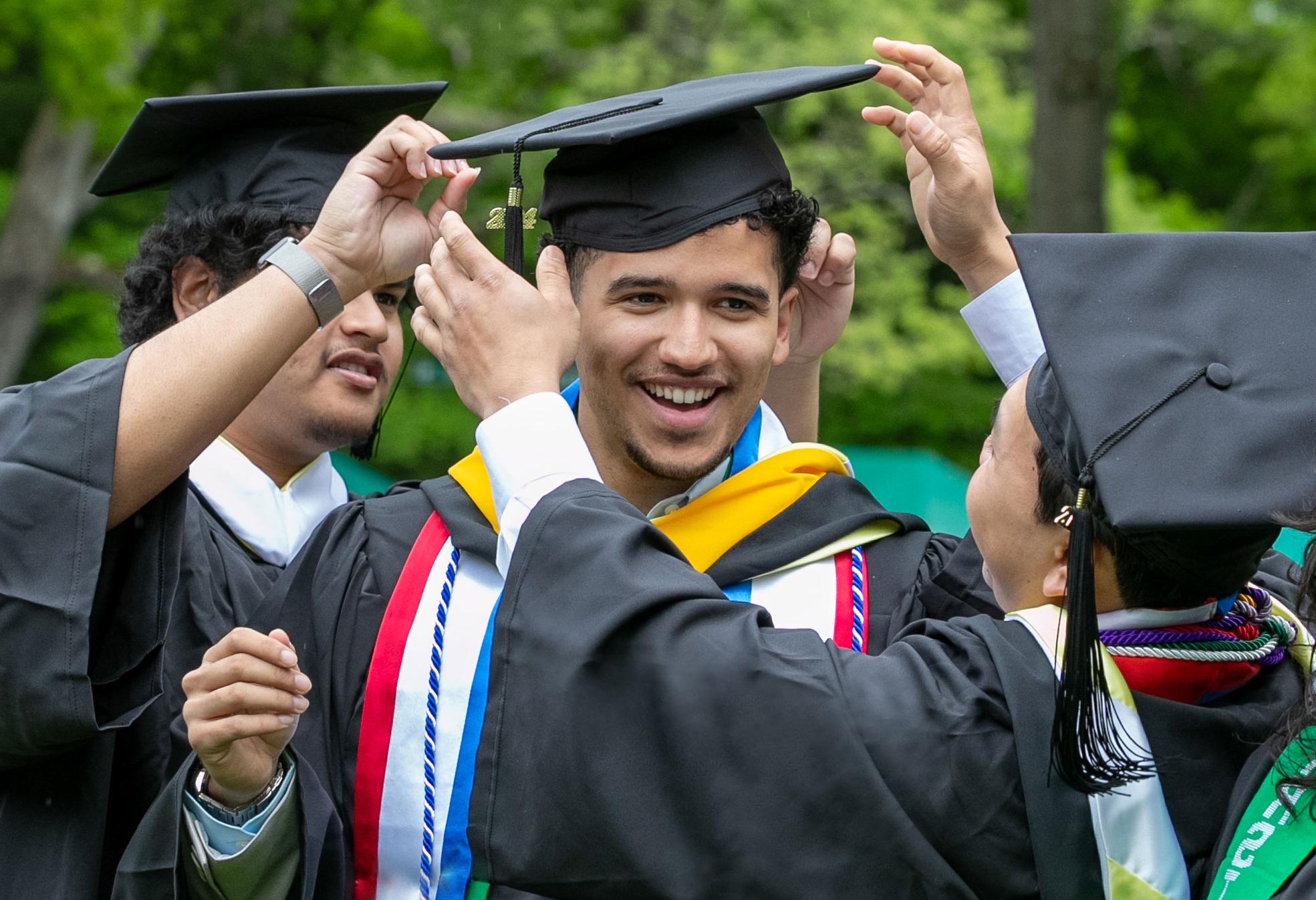 A student wearing a "first gen" stole graduates from college